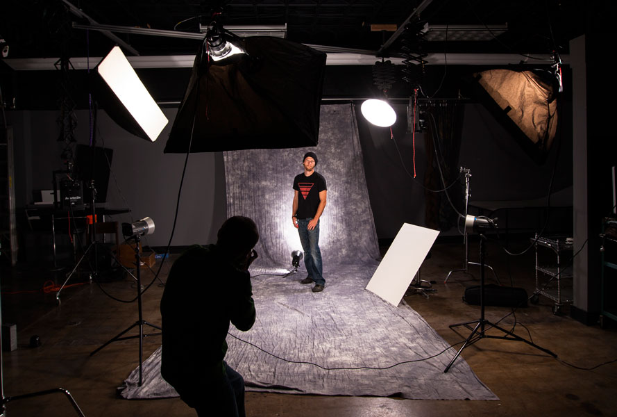 Student Anthony Petrone takes photos of Josh Larson for this semester's advanced studio/commercial photography class.