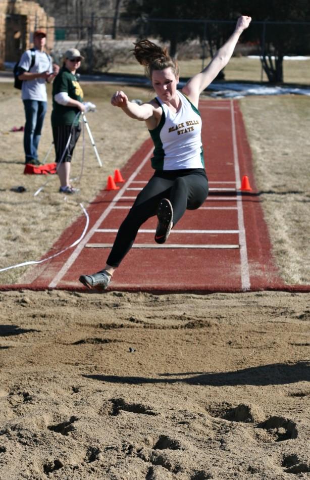 Paige Follet propels forward during the triple jump at the Yellow Jacket Spring Opening Track Meet. Follet won triple jump with 11.08 meters.