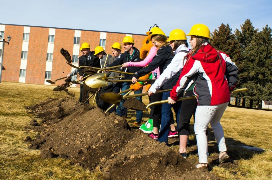 Students+and+administration+take+part+in+the+groundbreaking+for+new+residence+hall.+