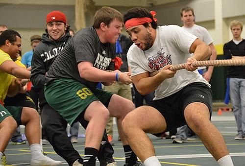 The Winona Cook hall men's tug-of-war team struggles against the opposing team at the All-Hall Battle in the Young Center.