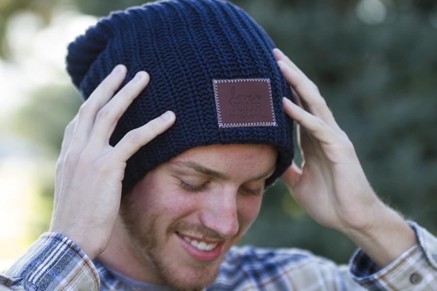 Riley Winter puts on one of the beanies he purchased from LYM. 