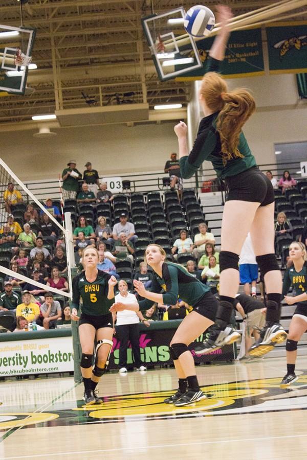 Kenzie+Kazmer+intercepts+the+ball+mid-air+in+the+volleyball+game+against+Western+New+Mexico+University+Sept.+26.