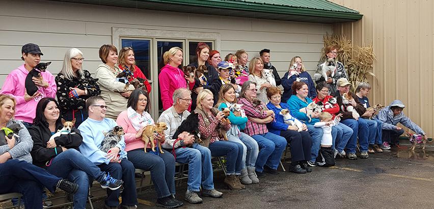 Chihuahuas and their new owners gather for a group picture at the Western Hills Humane Society second annual open house Oct. 3