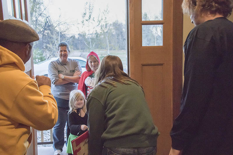 Black Hills State University Student Ambassadors Hannah Owens, Maddie Foster, Sam Hintgen and Sonja Pederson hand out candy and BHSU pencils at the President’s house Oct. 31. 