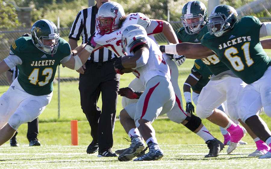 Thayer Sauter (43) and Lorenzo Tanner attempt to take down Western State Colorado during Swarm Week's Oct. 10 game.