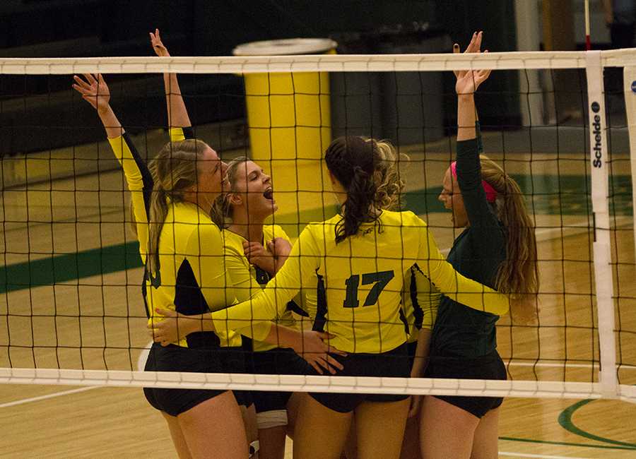 The team cheers after it scores a point against Regis during Swarm Week's Oct. 10 game.