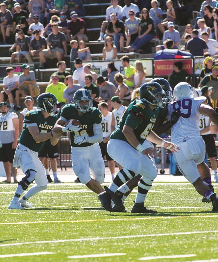 Black Hills State University running back Phydell Paris (#34) breaks through the defense to gain yardage during the game against New Mexico Highlands Cowboys Oct. 1.