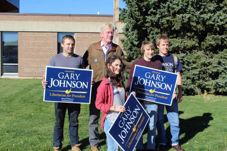 Black Hills State University Students stop to take pictures with Governor Bill Weld in front of the Jonas Science building before his speech in Club Buzz Oct. 20.