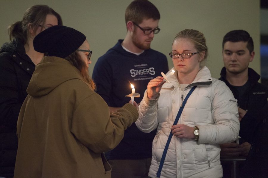 Black Hills State University students light candles during a candlelight vigil held for Meliora Bachelor in the Student Union Atrium Dec. 5.