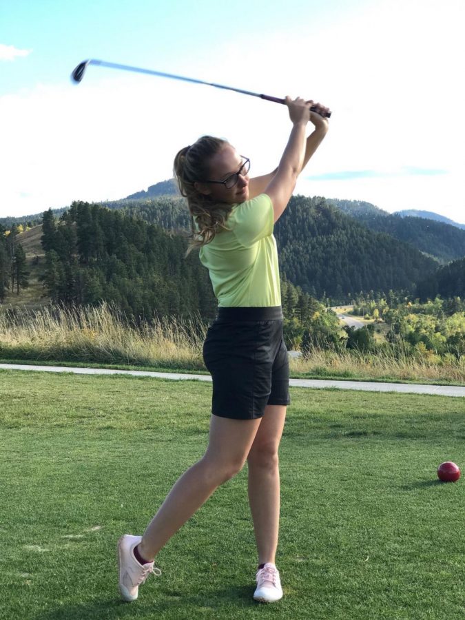 Freshman, Taryn Mayer, tests out a par-3 hole at the Pueblo course the day before the tournament 