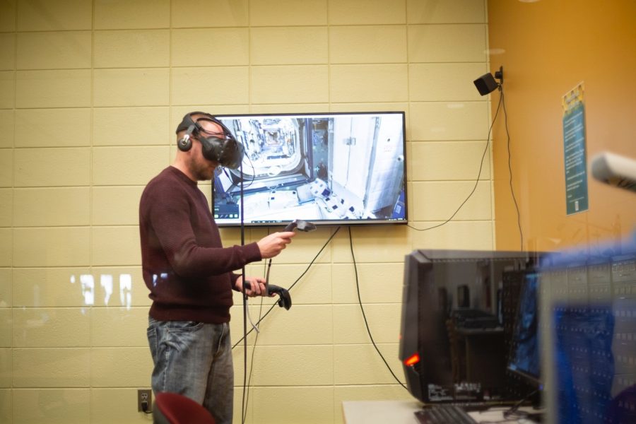 Aaron Bauerly, systems librarian, explores the International Space Station using virtual reality technology in the Innovation lab at BHSU.