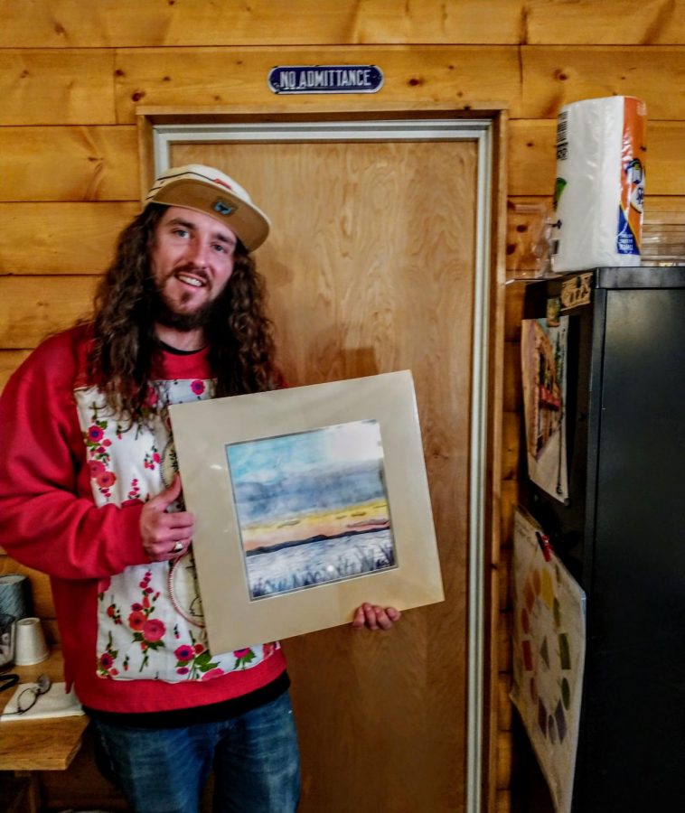 BHSU alumni Drew Dutton proudly displays his art piece in the gallery room of Artifacts, Antiques and Art, located in Spearfish, S.D.