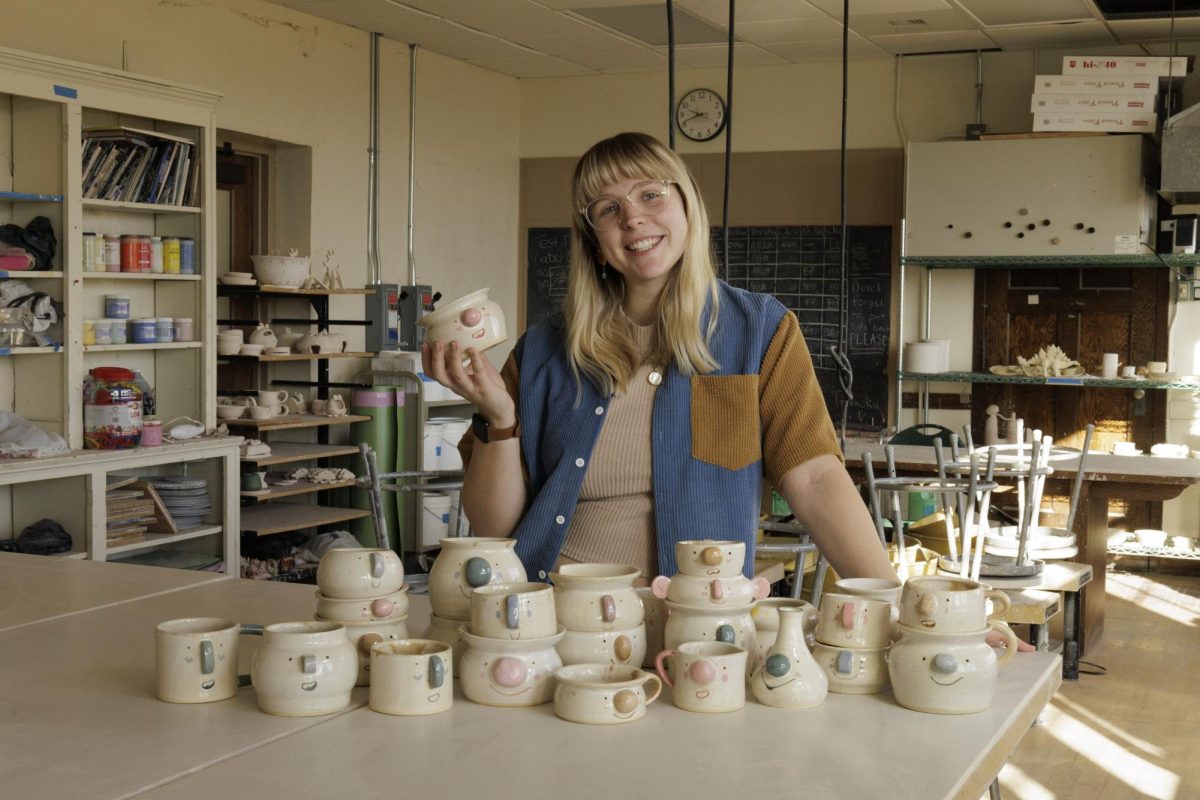 Lydia Derksen, a BHSU art major, in her studio with her ‘Nosey Neighbors’ ceramics series.