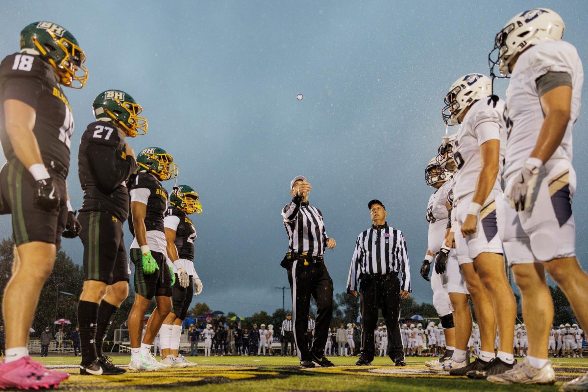 The captains of the BHSU and SDSM football teams line up for the coin toss prior to kicking off the 140th annual Black Hills Brawl Oct. 4.