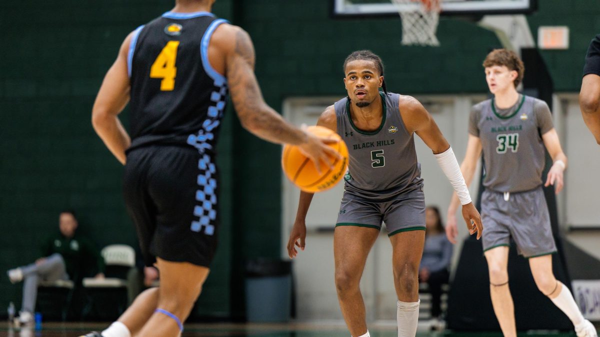 Trey Curry, a FLC freshman, challenges BHSU senior Myles Johnson during Jan. 26 game.